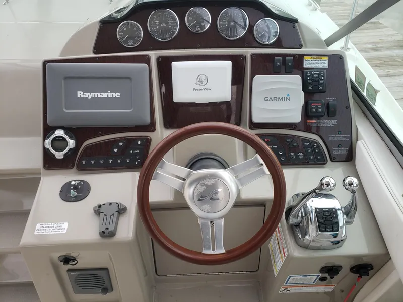 Slide: The Image of Cockpit of 2011 Sea Ray 350 Sundancer with Raymarine and Garmin navigation systems. - 10