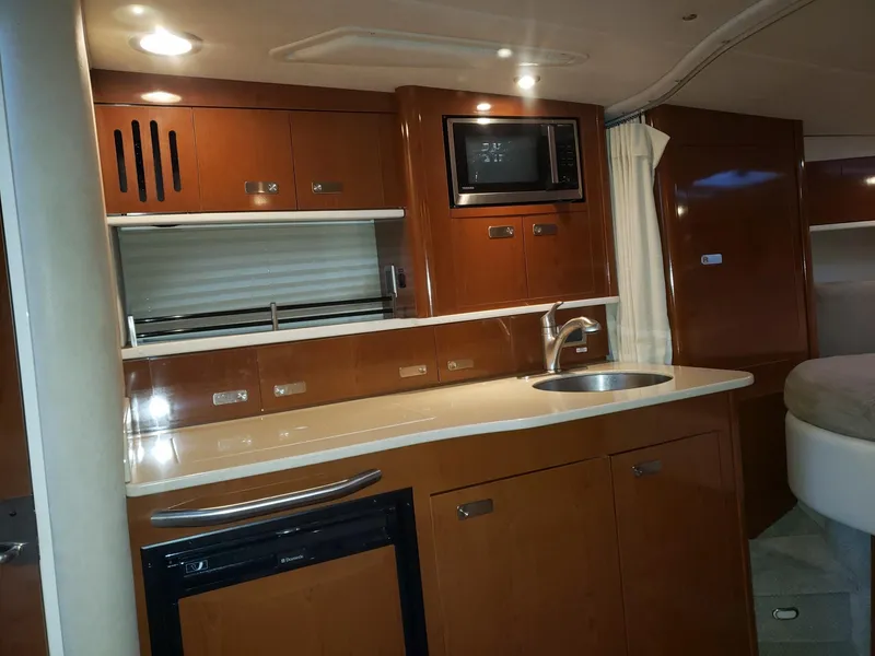 Slide: The Image of Interior of 2011 Sea Ray 350 Sundancer yacht with modern kitchen amenities. - 11