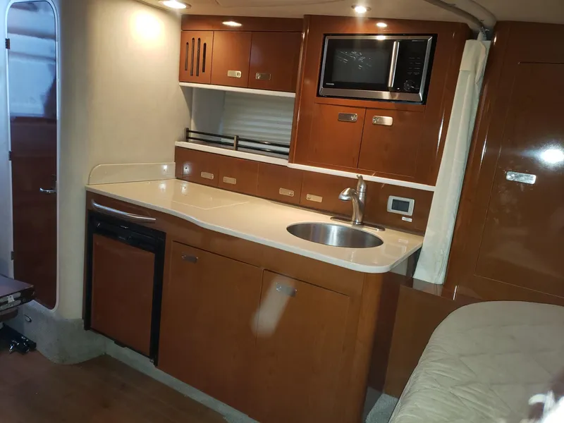 Slide: The Image of Interior of 2011 Sea Ray 350 Sundancer yacht with kitchenette and modern amenities. - 12
