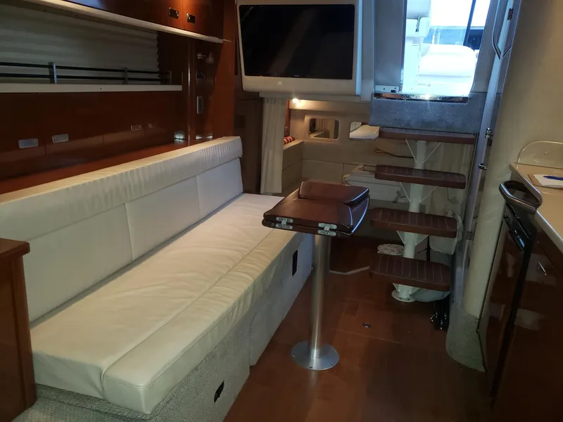 Slide: The Image of Interior of 2011 Sea Ray 350 Sundancer with sofa, table, and stairs. - 15