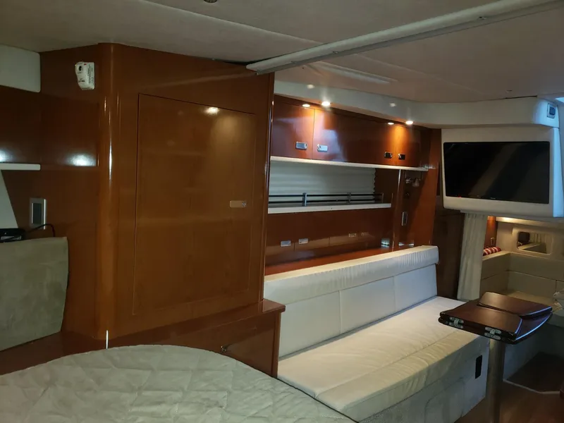 Slide: The Image of Interior of 2011 Sea Ray 350 Sundancer yacht with modern furnishings and ambient lighting. - 16