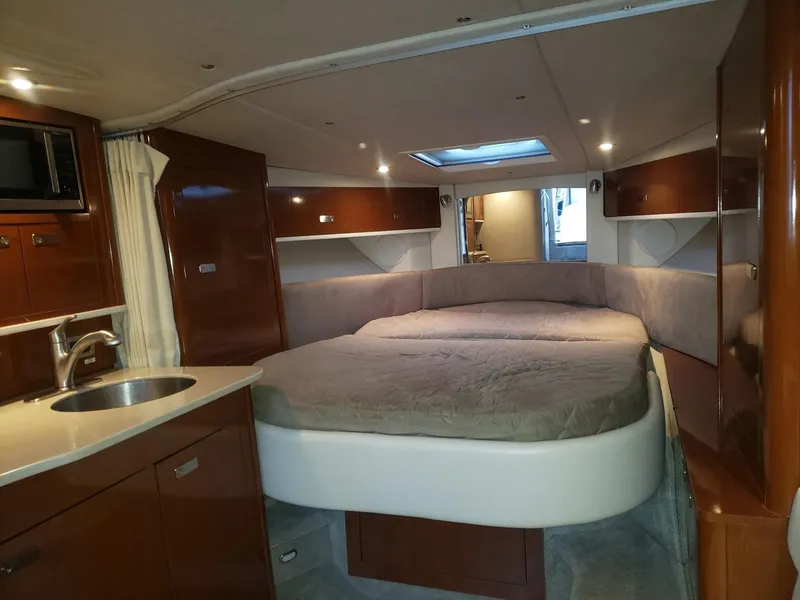 Slide: The Image of Luxurious interior of 2011 Sea Ray 350 Sundancer yacht with cozy bed and kitchenette. - 21