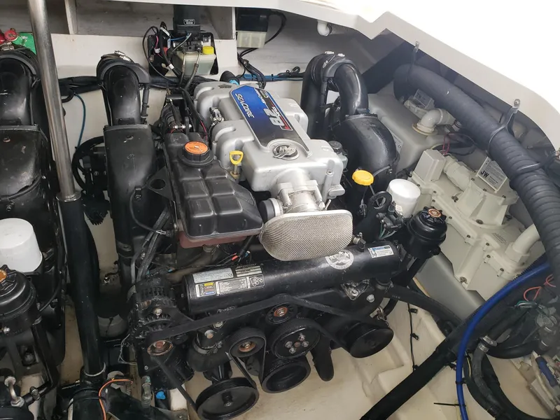 Slide: The Image of Engine compartment of a 2011 Sea Ray 350 Sundancer boat, showcasing detailed components. - 29