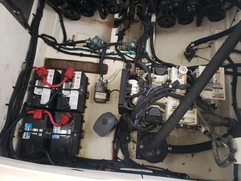 Slide: The Image of Engine compartment of a 2011 Sea Ray 350 Sundancer with batteries and wiring. - 30