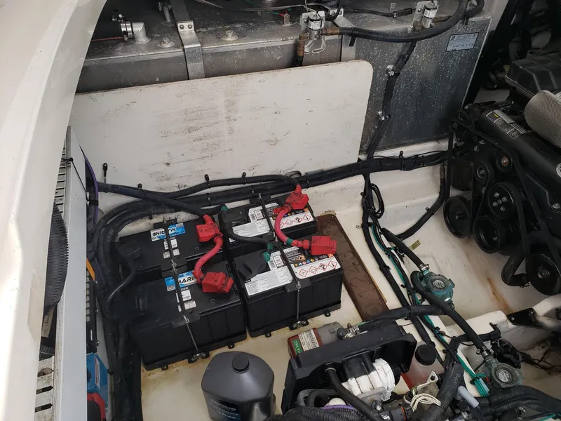 Slide: The Image of Engine compartment of a 2011 Sea Ray 350 Sundancer with batteries and wiring. - 31