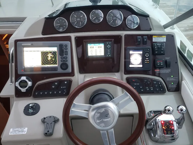 Slide: The Image of Cockpit of 2011 Sea Ray 350 Sundancer with navigation and control instruments. - 6