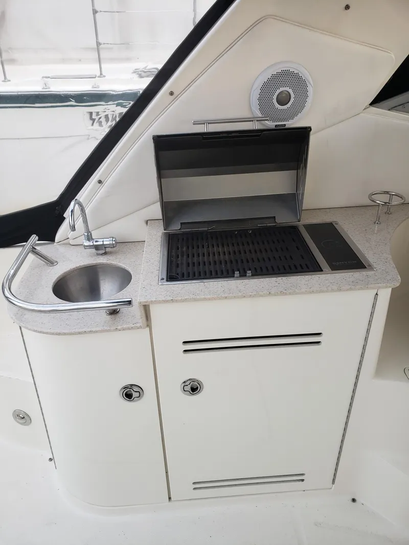 Slide: The Image of 2011 Sea Ray 350 Sundancer boat kitchenette with sink and grill. - 8
