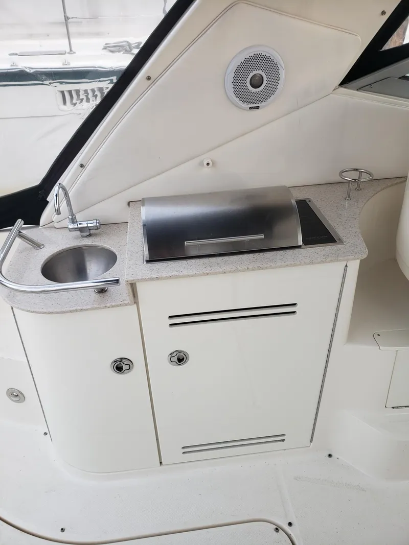 Slide: The Image of 2011 Sea Ray 350 Sundancer boat kitchenette with sink and grill. - 9