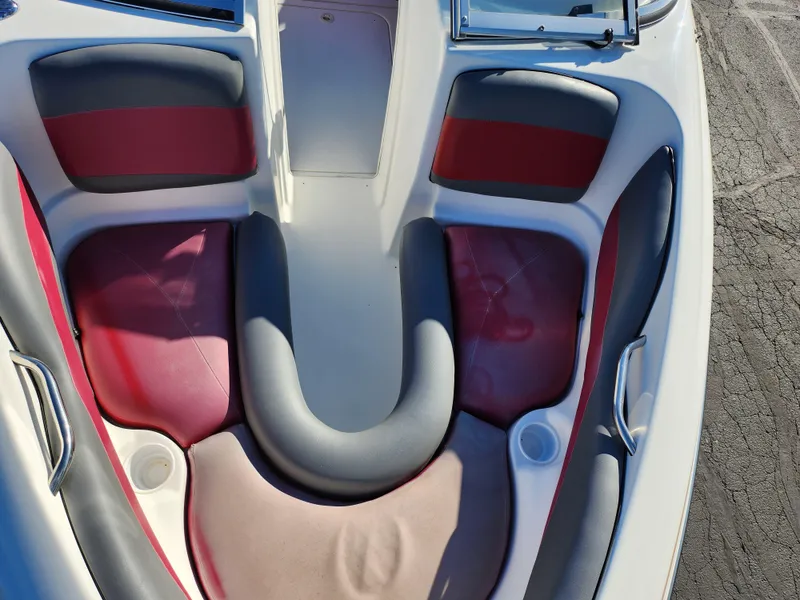 Slide: The Image of 2003 Larson SEi 180 boat interior with red and gray seating. - 16