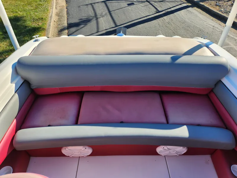 Slide: The Image of 2003 Larson SEi 180 boat interior with red and gray seating. - 19