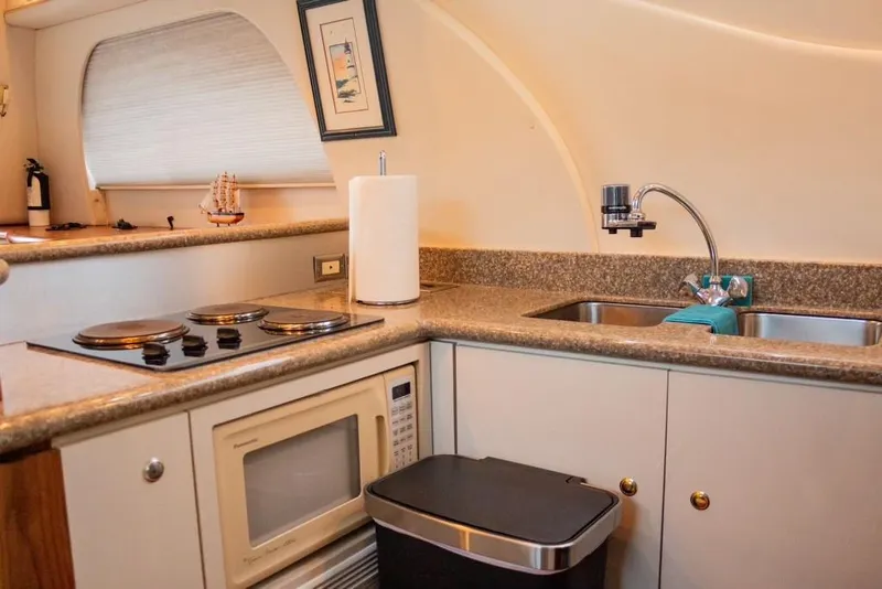 Slide: The Image of Compact kitchen in 1999 Maxum 4100 SCR yacht with stove, microwave, and sink. - 10