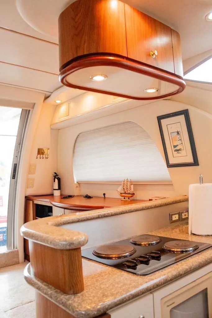 Slide: The Image of Interior of 1999 Maxum 4100 SCR yacht with modern kitchen amenities. - 11