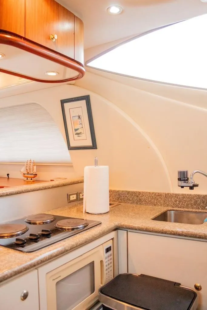 Slide: The Image of 1999 Maxum 4100 SCR yacht kitchen with modern appliances and sleek design. - 13