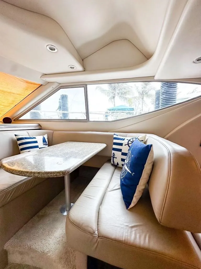 Slide: The Image of Luxurious interior of 1999 Maxum 4100 SCR yacht with plush seating and nautical decor. - 14