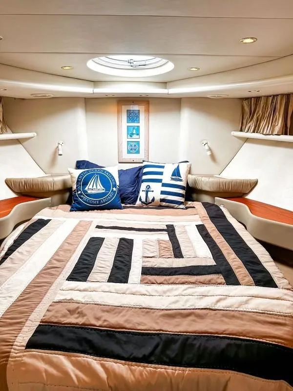 Slide: The Image of Luxurious 1999 Maxum 4100 SCR yacht cabin with nautical-themed bedding and decor. - 16