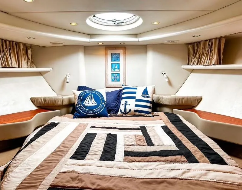 Slide: The Image of Luxurious 1999 Maxum 4100 SCR yacht cabin with nautical-themed decor and cozy bedding. - 17