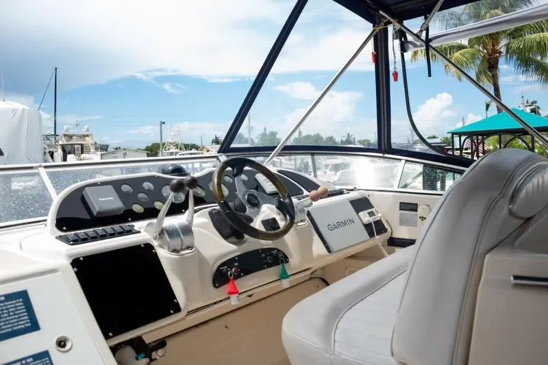 Slide: The Image of 1999 Maxum 4100 SCR boat cockpit with Garmin navigation, steering wheel, and controls. - 2