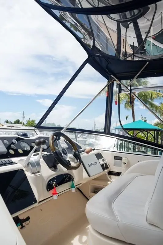 Slide: The Image of 1999 Maxum 4100 SCR yacht cockpit with steering wheel and navigation equipment. - 4