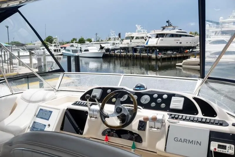 Slide: The Image of Maxum 4100 SCR 1999 yacht cockpit with Garmin navigation, docked at marina. - 6