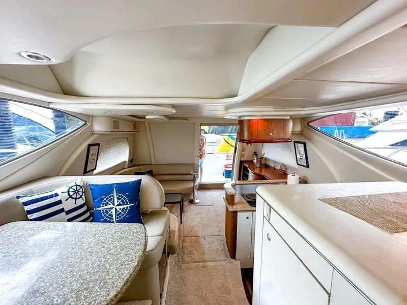 Slide: The Image of Interior of 1999 Maxum 4100 SCR yacht with modern furnishings and nautical decor. - 7