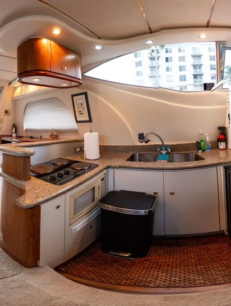 Slide: The Image of Luxurious 1999 Maxum 4100 SCR yacht kitchen with modern amenities and sleek design. - 8
