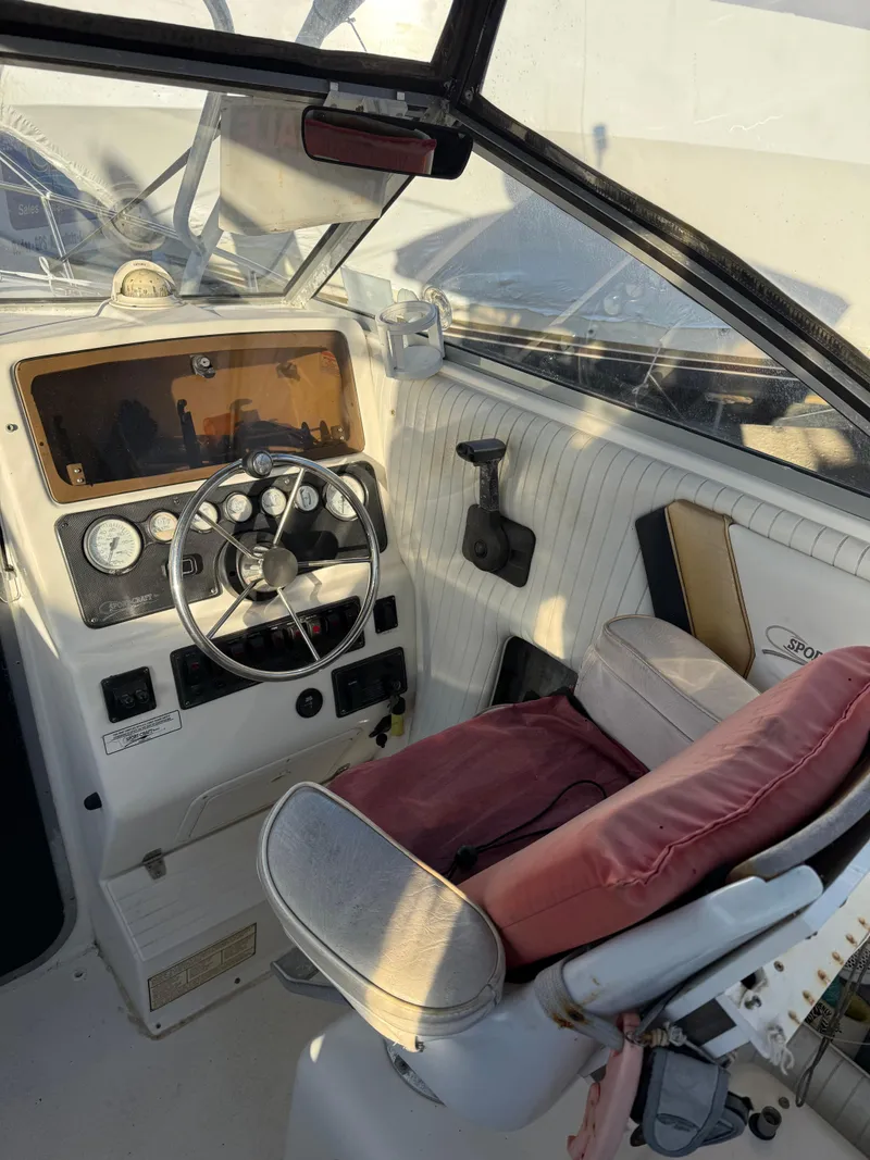 Slide: The Image of 1998 Sport-Craft 252 Sportfish boat on trailer, parked outdoors under clear sky. - 4
