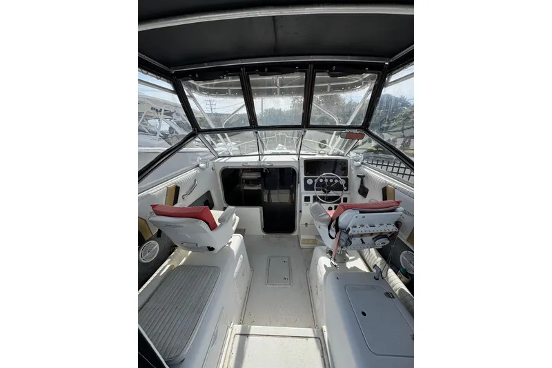 Slide: The Image of Interior view of 1998 Sport-Craft 252 Sportfish boat cockpit with seating and controls. - 6
