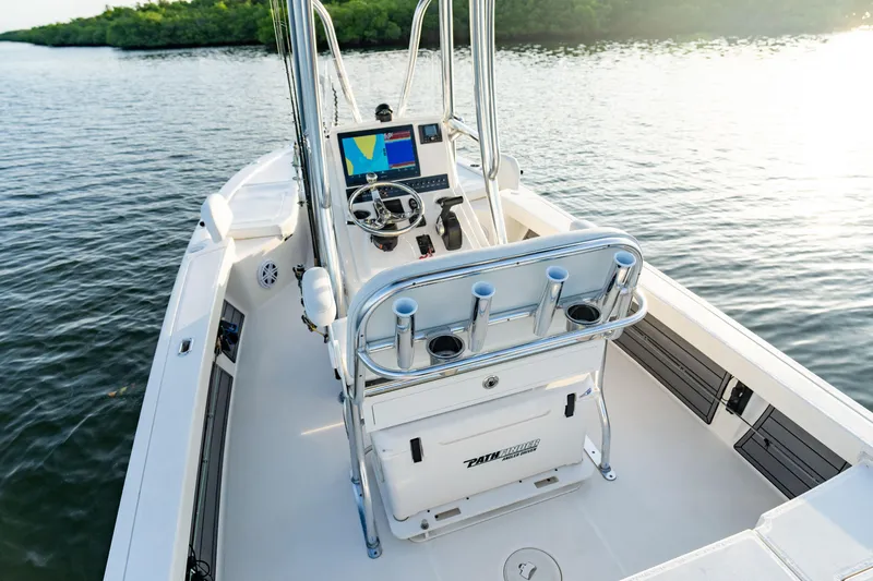 Slide: The Image of 2025 Pathfinder 2200 TRS boat with T-top, parked in a dealership lot. - 13