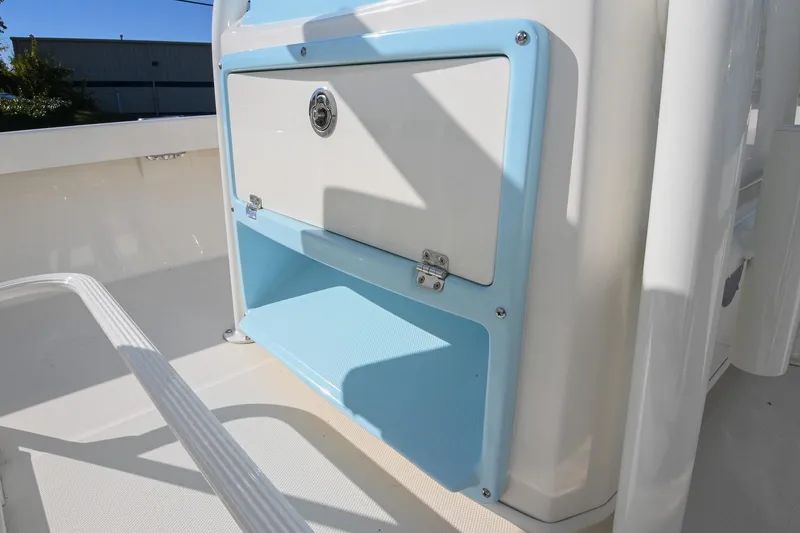Slide: The Image of 2025 Pathfinder 2200 TRS boat console with blue trim and storage compartment. - 19