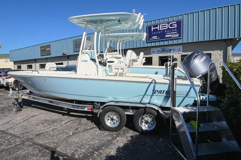 Slide: The Image of 2025 Pathfinder 2200 TRS boat on trailer at HBG Yacht Sales dealership. - 2