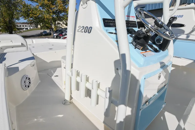 Slide: The Image of 2025 Pathfinder 2200 TRS boat interior with steering console and rod holders. - 22
