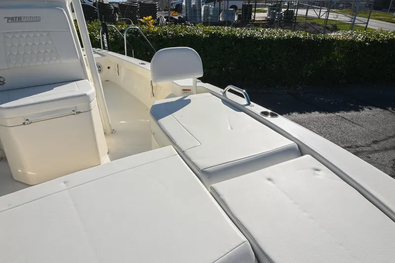 Slide: The Image of 2025 Pathfinder 2200 TRS boat interior with cushioned seating and storage compartments. - 33