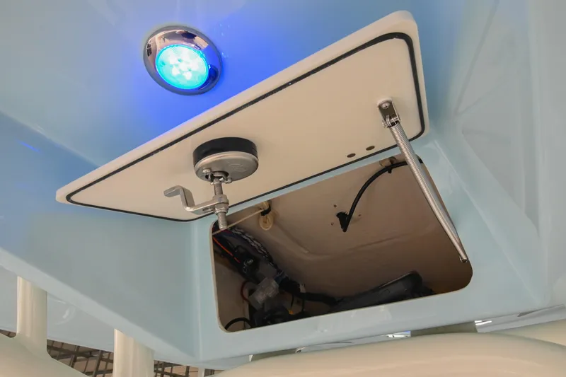 Slide: The Image of 2025 Pathfinder 2200 TRS boat compartment with blue LED light and open hatch. - 37