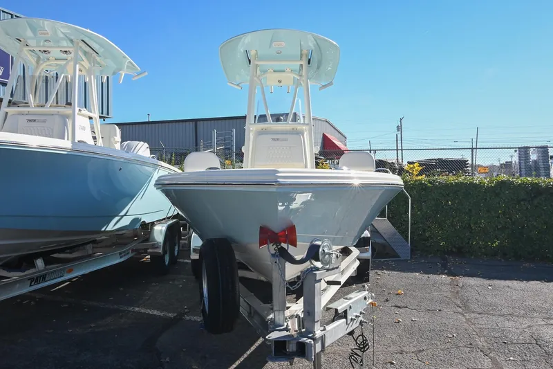Slide: The Image of 2025 Pathfinder 2200 TRS boat on trailer, displayed outdoors under clear blue sky. - 4