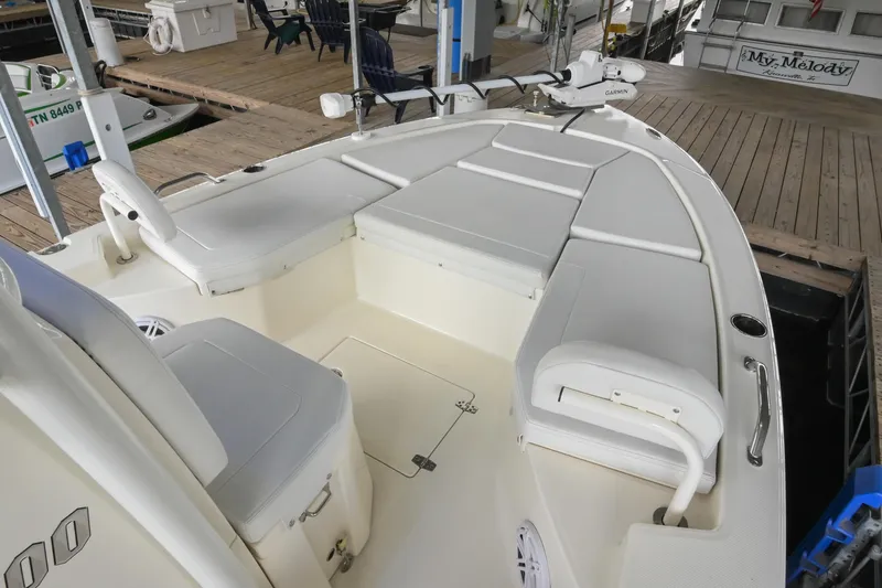 Slide: The Image of 2025 Pathfinder 2200 TRS boat interior with cushioned seating and deck view. - 42