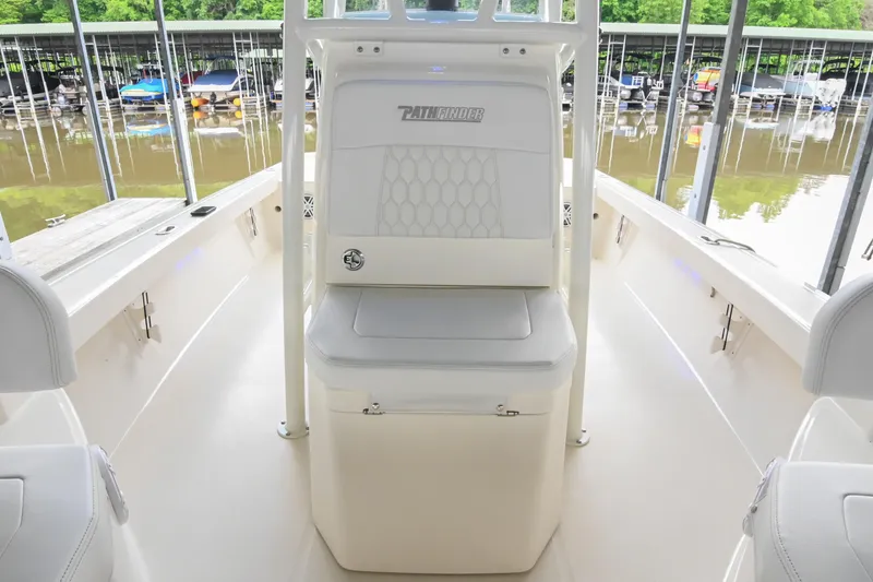 Slide: The Image of 2025 Pathfinder 2200 TRS boat interior with seating, docked at marina. - 43