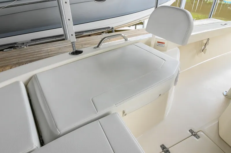 Slide: The Image of 2025 Pathfinder 2200 TRS boat interior with white cushioned seating and sleek design. - 46