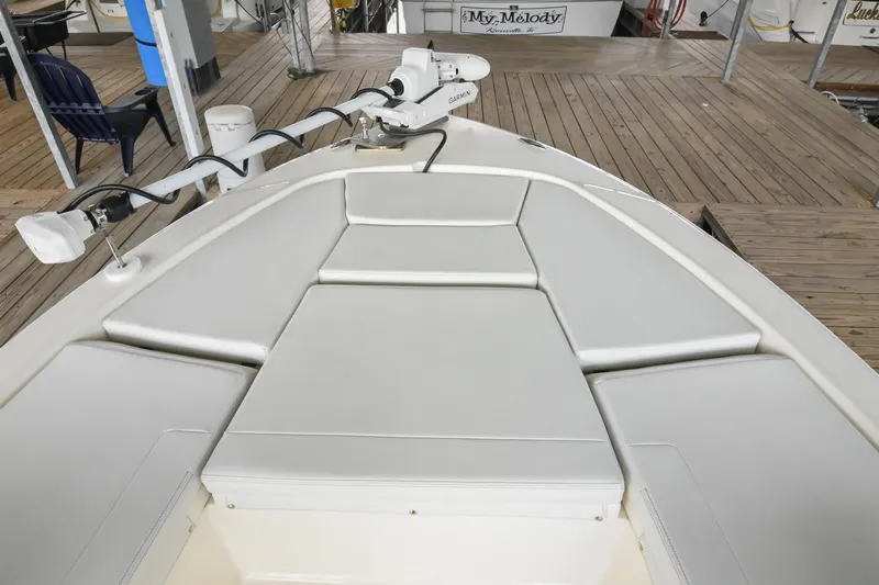 Slide: The Image of 2025 Pathfinder 2200 TRS boat with cushioned bow seating and Garmin equipment at dock. - 48