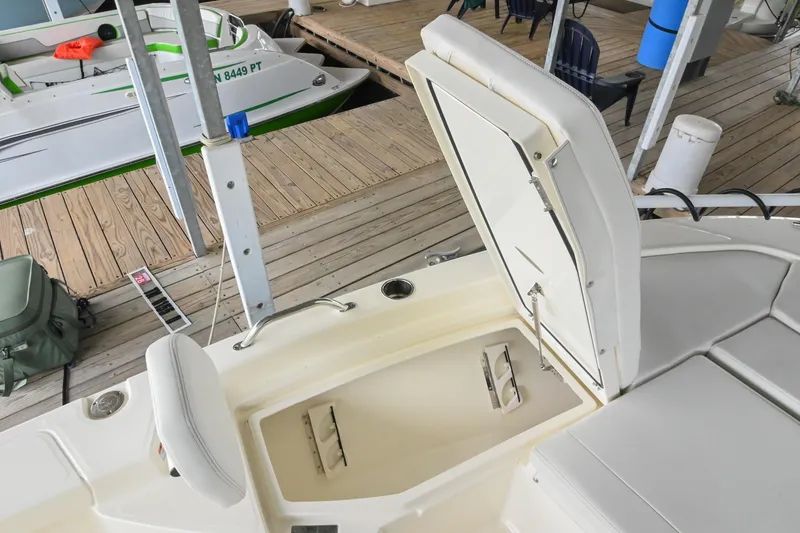 Slide: The Image of 2025 Pathfinder 2200 TRS boat with open storage compartment at dock. - 51