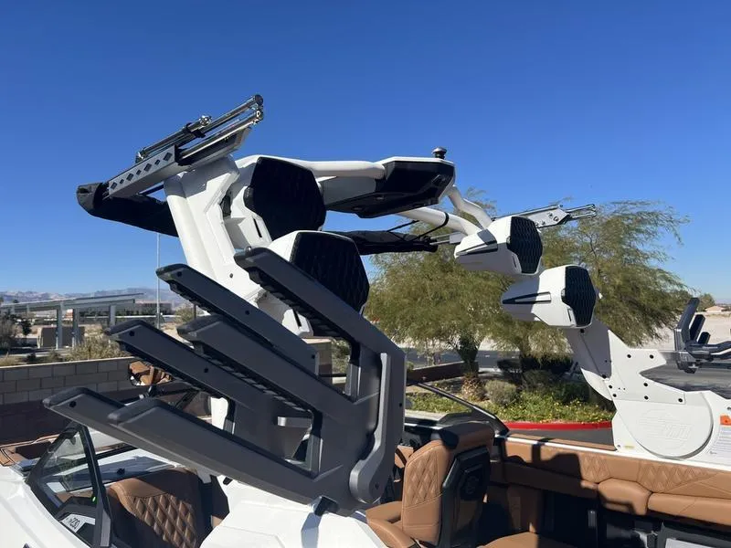 Slide: The Image of 2025 Malibu M230 boat with advanced wakeboard tower and luxurious interior. - 10