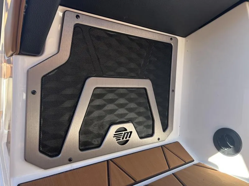 Slide: The Image of 2025 Malibu M230 boat speaker with stylish grille design. - 13