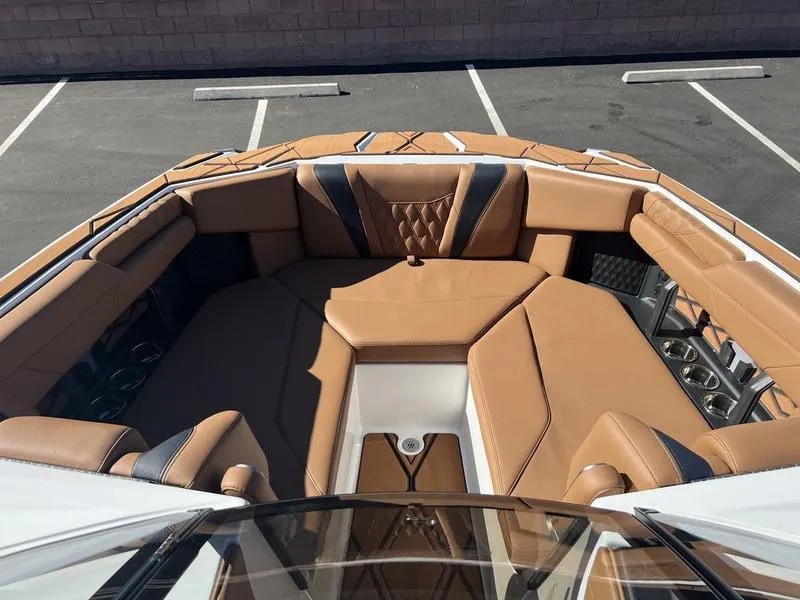 Slide: The Image of Luxurious interior of 2025 Malibu M230 boat with tan leather seating. - 15