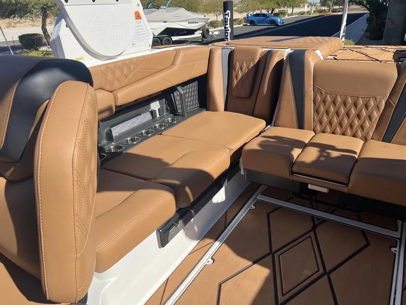 Slide: The Image of Luxurious tan leather seating in 2025 Malibu M230 boat interior. - 18