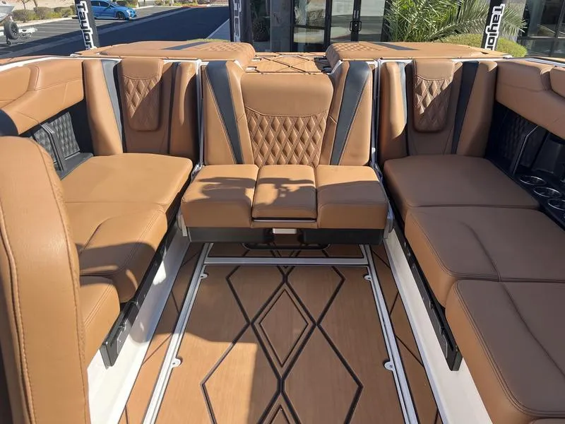 Slide: The Image of Luxurious interior of 2025 Malibu M230 boat with tan leather seating and stylish flooring. - 19