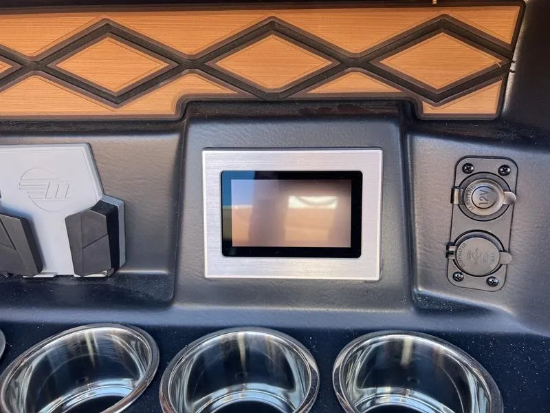 Slide: The Image of 2025 Malibu M230 dashboard with touchscreen and cup holders. - 20