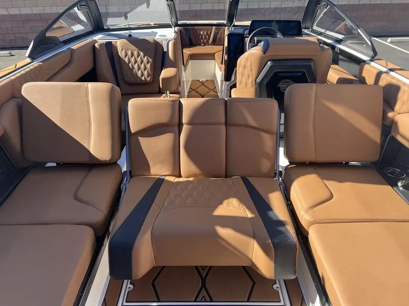 Slide: The Image of 2025 Malibu M230 boat interior with luxurious tan leather seating. - 22