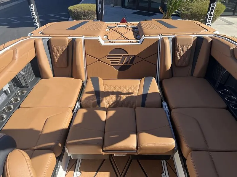 Slide: The Image of Luxurious interior of 2025 Malibu M230 boat with tan leather seating. - 23