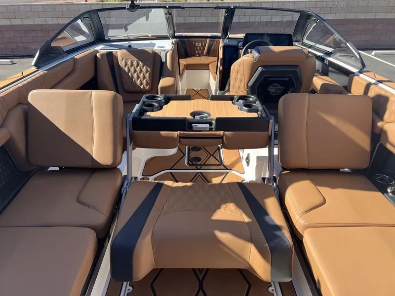 Slide: The Image of 2025 Malibu M230 boat interior with luxurious brown leather seating and modern design. - 24