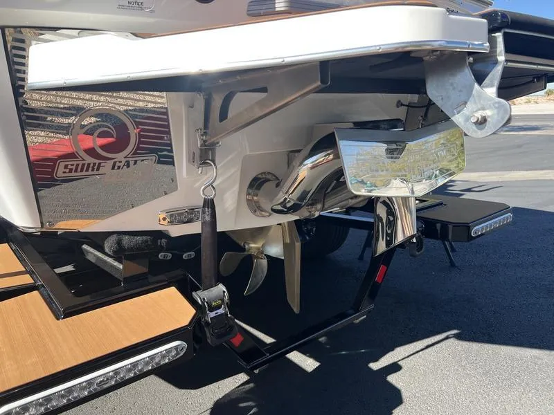 Slide: The Image of 2025 Malibu M230 boat stern with propeller and Surf Gate system. - 25