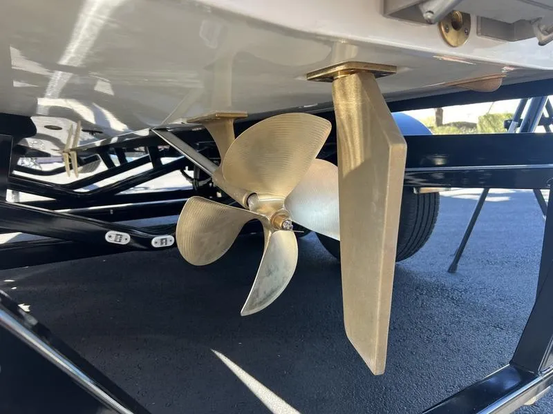 Slide: The Image of 2025 Malibu M230 boat propeller and rudder detail on trailer. - 3